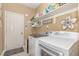 Functional laundry room with washer, dryer, shelving, and storage space, perfect for keeping organized at 45 Pebble Creek Dr, Franklinton, NC 27525