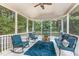 Inviting sunroom with comfortable seating, ceiling fan, and scenic views of the surrounding greenery at 45 Pebble Creek Dr, Franklinton, NC 27525