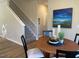 Cozy dining area with a wooden table set for two, adjacent to the stairway at 46 Atherton Circle, Angier, NC 27501