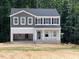 Two-story home with a gray roof, vinyl siding, an attached garage, and a covered front porch under construction at 46 Atherton Circle, Angier, NC 27501