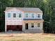 Two-story home featuring multiple windows ready for siding and other exterior finishes at 46 Atherton Circle, Angier, NC 27501