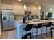 Modern kitchen with stainless steel appliances, granite countertops, and breakfast bar seating at 46 Atherton Circle, Angier, NC 27501