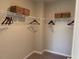 Empty walk-in closet features hanging rods and shelves for ample storage at 46 Atherton Circle, Angier, NC 27501