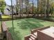 Spacious backyard featuring manicured artificial grass, privacy fence, and a brick patio at 4724 Worchester Pl, Raleigh, NC 27604