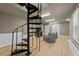 Finished basement with spiral staircase, modern lighting, wood floors, and cozy seating area at 4724 Worchester Pl, Raleigh, NC 27604
