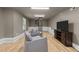 Finished basement with comfortable seating and a spiral staircase at 4724 Worchester Pl, Raleigh, NC 27604