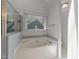 Bathroom with a large tub situated beneath a window for natural light at 4724 Worchester Pl, Raleigh, NC 27604