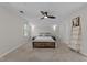 Bright bedroom with a ceiling fan, carpet floors and ambient sconce lighting at 4724 Worchester Pl, Raleigh, NC 27604