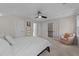 Carpeted bedroom with ceiling fan, closet, and doorway to another room at 4724 Worchester Pl, Raleigh, NC 27604