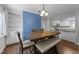 Open-concept dining room with a wood table, bench seating, and a view into the adjacent kitchen at 4724 Worchester Pl, Raleigh, NC 27604