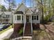 Charming home with a brick foundation, stairs leading to the front door, and manicured landscaping at 4724 Worchester Pl, Raleigh, NC 27604