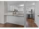 Bright kitchen with stainless steel appliances, granite countertops, a breakfast bar, and hardwood floors at 4724 Worchester Pl, Raleigh, NC 27604