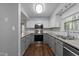 Modern kitchen with stainless steel appliances, granite countertops, subway tile backsplash, and hardwood floors at 4724 Worchester Pl, Raleigh, NC 27604
