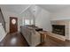 Cozy living room with vaulted ceilings, a brick fireplace, hardwood floors, and a bay window at 4724 Worchester Pl, Raleigh, NC 27604