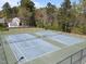 Aerial view of well-maintained community tennis courts, surrounded by trees and fencing at 4724 Worchester Pl, Raleigh, NC 27604