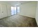Bright bedroom with plush carpeting and a sliding glass door to bring in natural light at 4907 Hollenden Dr # 105, Raleigh, NC 27616