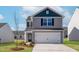 Charming two-story home with a two-car garage and well-manicured lawn at 54 Crow Field St, Roxboro, NC 27574