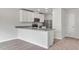 Modern kitchen with white cabinets, granite countertops, and stainless steel appliances at 54 Crow Field St, Roxboro, NC 27574