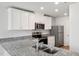 Contemporary kitchen with stainless steel appliances, white cabinetry, and granite countertops at 54 Crow Field St, Roxboro, NC 27574