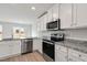 Modern kitchen featuring stainless steel appliances and granite countertops at 54 Crow Field St, Roxboro, NC 27574