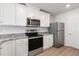 Well-equipped kitchen with stainless steel appliances and white cabinets at 54 Crow Field St, Roxboro, NC 27574