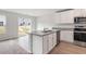 Stylish kitchen island with granite countertop, stainless steel sink and a view of the backyard at 54 Crow Field St, Roxboro, NC 27574