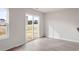 Bright living room with wood-look floors and sliding glass doors to the backyard at 54 Crow Field St, Roxboro, NC 27574
