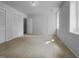 Bedroom offers neutral carpet, two closets, a door to another room, and natural light at 5620 Hamstead Xing, Raleigh, NC 27612