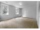 Bright bedroom features neutral walls, carpet, and two windows at 5620 Hamstead Xing, Raleigh, NC 27612
