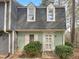 Charming home with a unique roofline, light green wood paneling and well manicured landscaping at 5620 Hamstead Xing, Raleigh, NC 27612