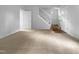Open living room features neutral carpet and access to the staircase and additional room at 5620 Hamstead Xing, Raleigh, NC 27612