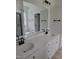 Bathroom featuring double sinks, a large mirror, and modern black hardware at 5710 Russell Rd, Durham, NC 27712