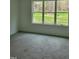 Comfortable carpeted bedroom features large windows for plenty of natural light at 5710 Russell Rd, Durham, NC 27712