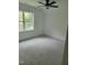 A bright bedroom features a window view and neutral carpeting at 5710 Russell Rd, Durham, NC 27712