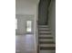 A light-filled entryway leads to the upper floor by a staircase with wood treads and white risers at 5710 Russell Rd, Durham, NC 27712