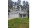 Charming single-story home featuring a two car garage and well-manicured lawn at 5710 Russell Rd, Durham, NC 27712