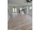 Bright living room showcases an island kitchen, wood floors, and outdoor access at 5710 Russell Rd, Durham, NC 27712