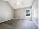 Bright bedroom with vaulted ceilings, ceiling fan, carpeted floors, and a sunny window view at 5908 O C Hester Rd, Holly Springs, NC 27540