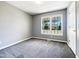 Neutral bedroom with gray walls, plush gray carpet, and a bright window view at 5908 O C Hester Rd, Holly Springs, NC 27540