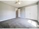 Spacious bedroom with neutral colors, a ceiling fan, and built-in wardrobe for ample storage at 5908 O C Hester Rd, Holly Springs, NC 27540