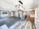 Open-concept living room and kitchen with modern lighting and flooring at 5908 O C Hester Rd, Holly Springs, NC 27540