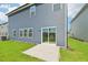 Back exterior of home with sliding glass door leading to concrete patio at 601 White Birch Ln, Angier, NC 27501