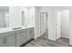 Bathroom features gray wood-look floors and double vanity with gray cabinets and white countertop at 601 White Birch Ln, Angier, NC 27501