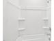 A well-lit, white bathtub and shower combination with shelving niches at 601 White Birch Ln, Angier, NC 27501