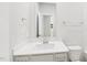 Bright bathroom vanity with a large mirror, white sink, and toilet at 601 White Birch Ln, Angier, NC 27501