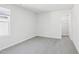 A bright, carpeted room features a window and closet, providing natural light and storage at 601 White Birch Ln, Angier, NC 27501