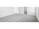 Bright bedroom featuring neutral walls and gray carpeting, with doorways leading to other rooms at 601 White Birch Ln, Angier, NC 27501