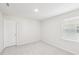 Well-lit bedroom featuring neutral carpet and window, plus a door at 601 White Birch Ln, Angier, NC 27501