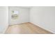 A bright, empty bedroom with hardwood floors and a large window with blinds at 601 White Birch Ln, Angier, NC 27501