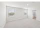 Bright bedroom with neutral carpet, white walls and two windows at 601 White Birch Ln, Angier, NC 27501